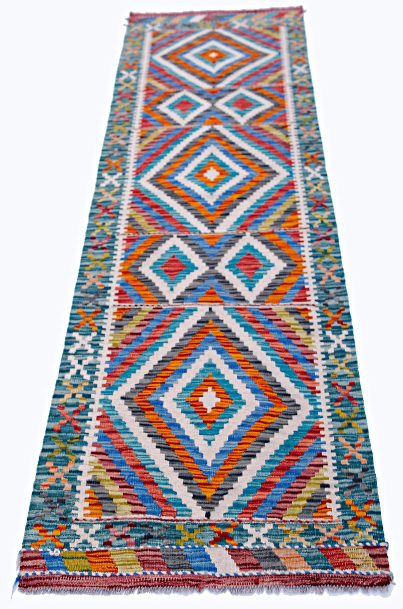 A handmade Afghan Maimana wool runner rug featuring a vibrant geometric diamond pattern.