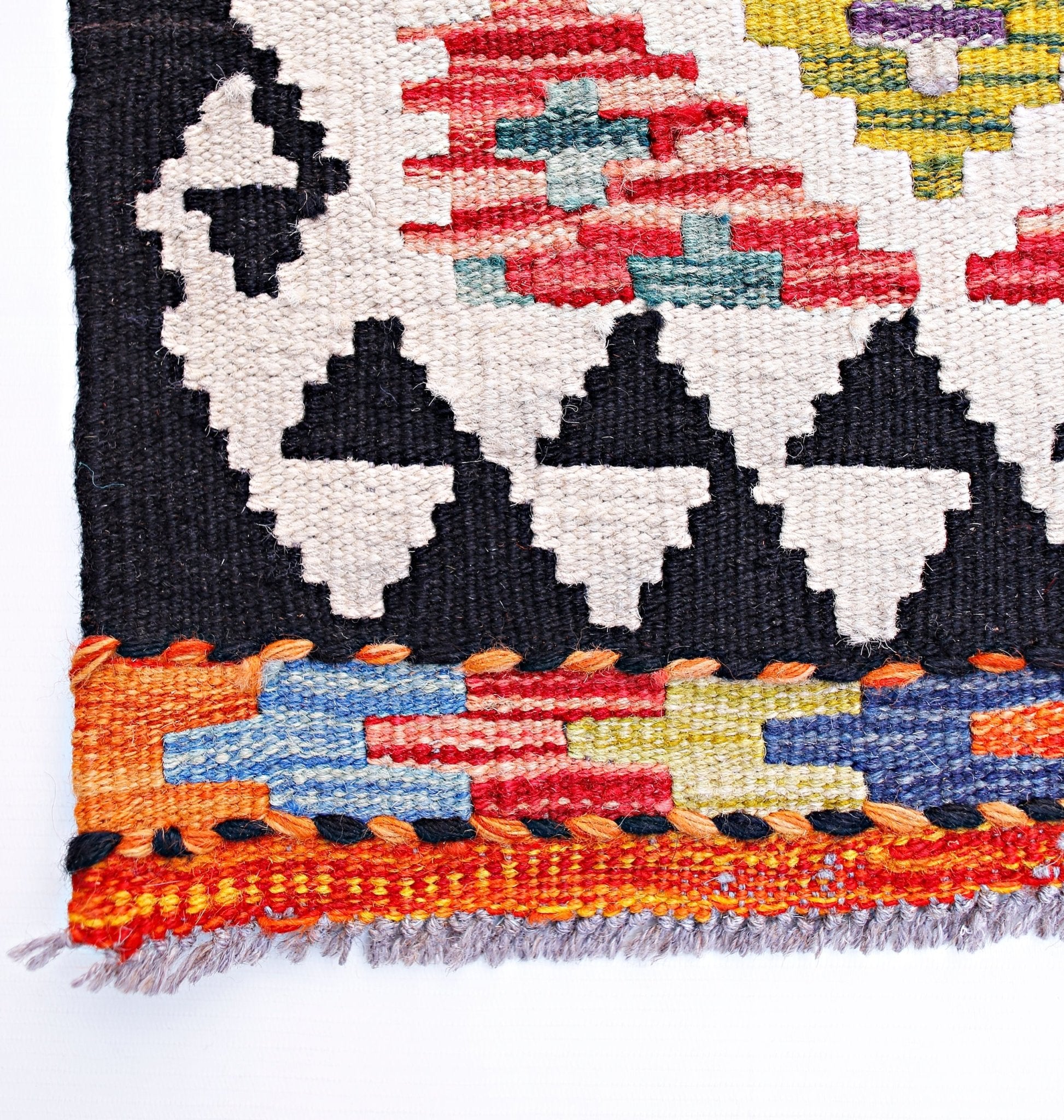 Handwoven Afghan Maimana wool kilim runner featuring geometric patterns in vibrant colors.