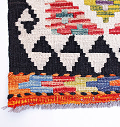 Handwoven Afghan Maimana wool kilim runner featuring geometric patterns in vibrant colors.