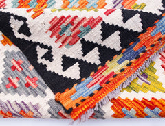 A handwoven Afghan Maimana wool kilim runner featuring a vibrant geometric pattern.