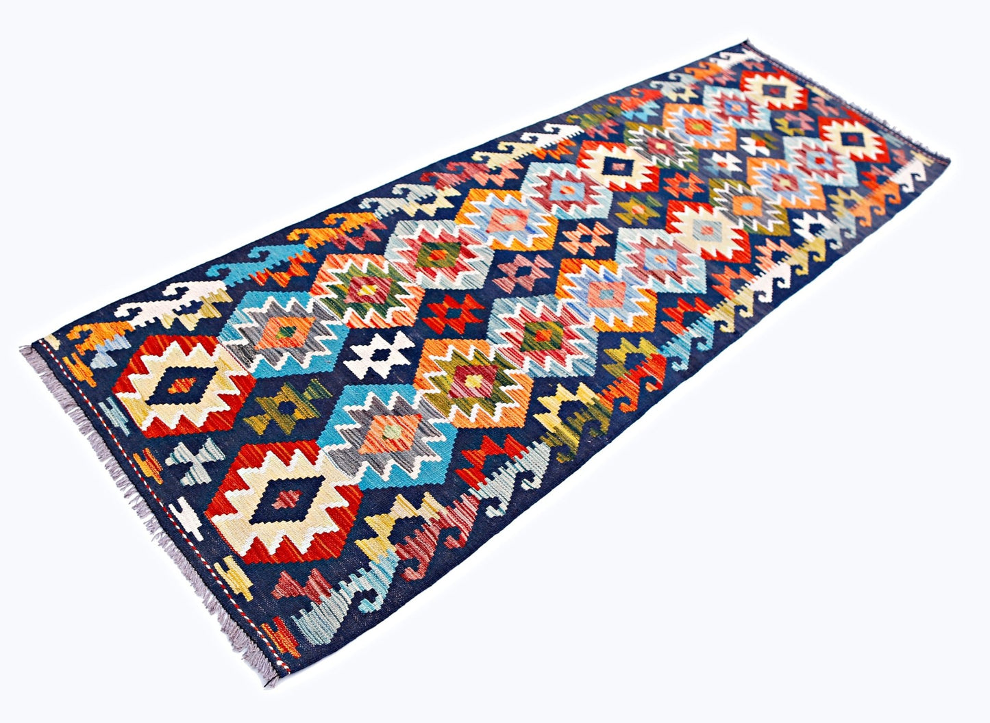 Handwoven Afghan Maimana wool runner rug featuring a vibrant geometric pattern on a dark blue base.