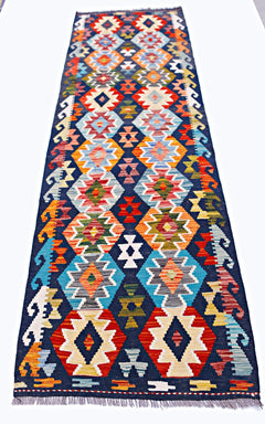 Handwoven Afghan Maimana wool runner rug featuring a colorful geometric diamond pattern.