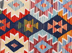 A handmade Afghan Maimana kilim runner featuring a vibrant geometric pattern in wool.