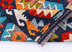 A handmade Afghan Maimana kilim runner featuring a vibrant geometric pattern in wool.