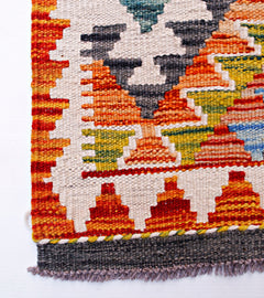 Handwoven Afghan Maimana wool runner featuring a geometric pattern in vibrant multicolored tones.