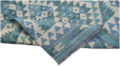A handmade Afghan Maimana wool runner featuring a blue and cream geometric pattern.