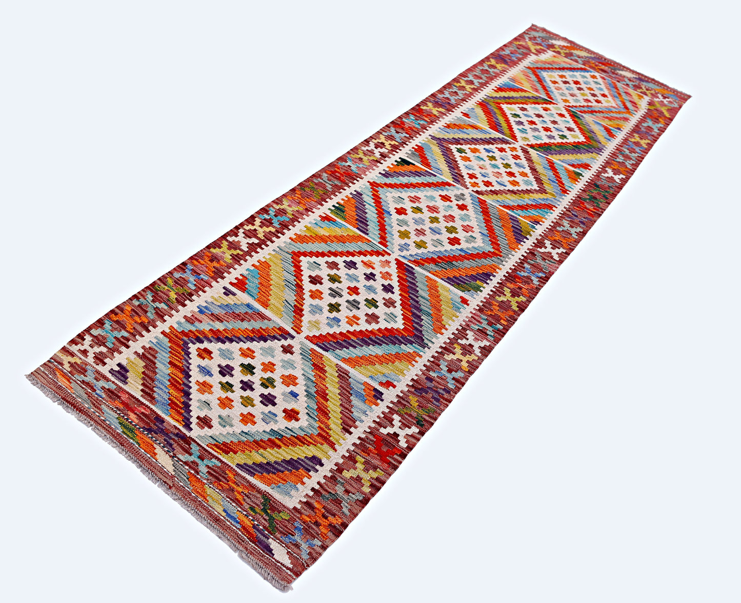 Handmade Afghan Maimana wool runner rug featuring a colorful geometric diamond pattern.