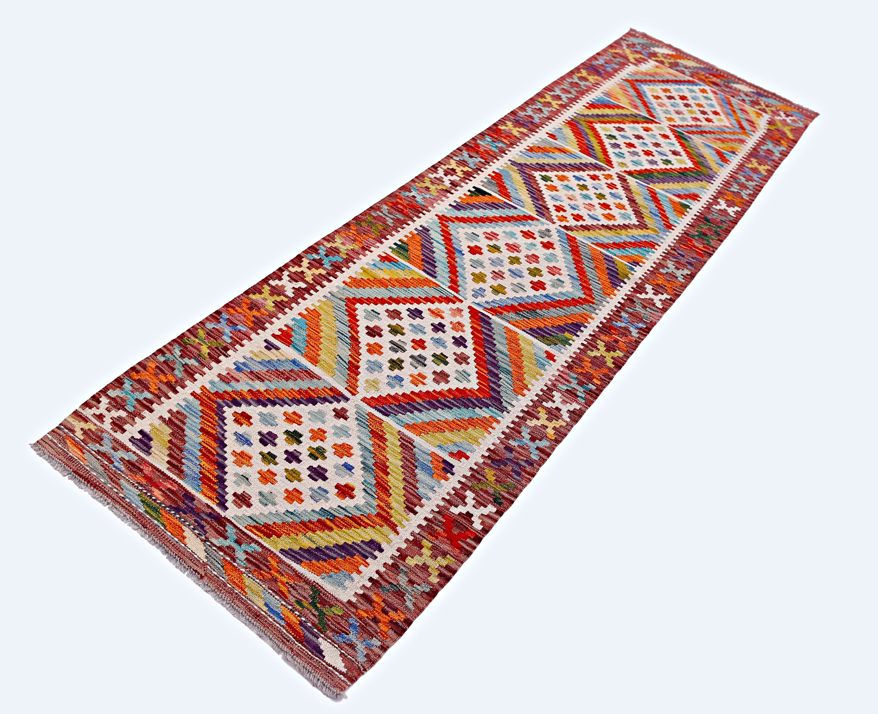 Handmade Afghan Maimana wool runner rug featuring a colorful geometric diamond pattern.