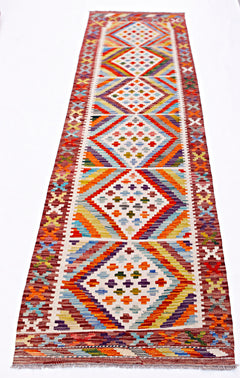 Handwoven Afghan Maimana wool runner rug featuring a colorful geometric diamond pattern.