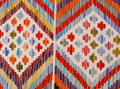 Handwoven Afghan Maimana wool kilim runner featuring a vibrant geometric diamond pattern.