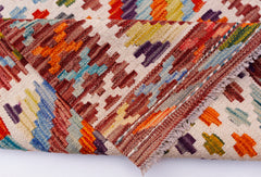 A handmade Afghan Maimana kilim runner featuring a colorful geometric pattern on a wool base.