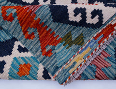 A handmade Afghan Maimana kilim runner featuring intricate geometric patterns in vibrant colors.