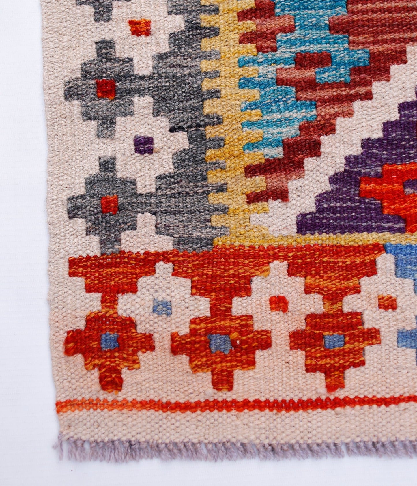 Handwoven Afghan Maimana wool kilim runner featuring a geometric pattern in vibrant colors.