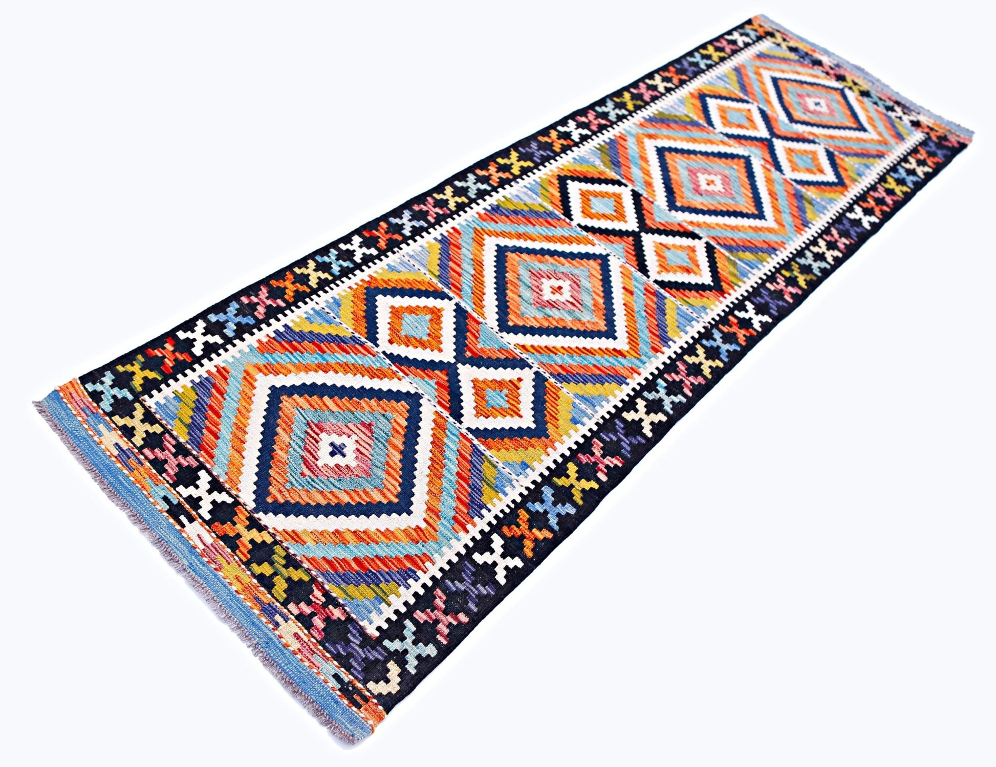 A handmade Afghan Maimana wool runner rug featuring a vibrant geometric diamond pattern.