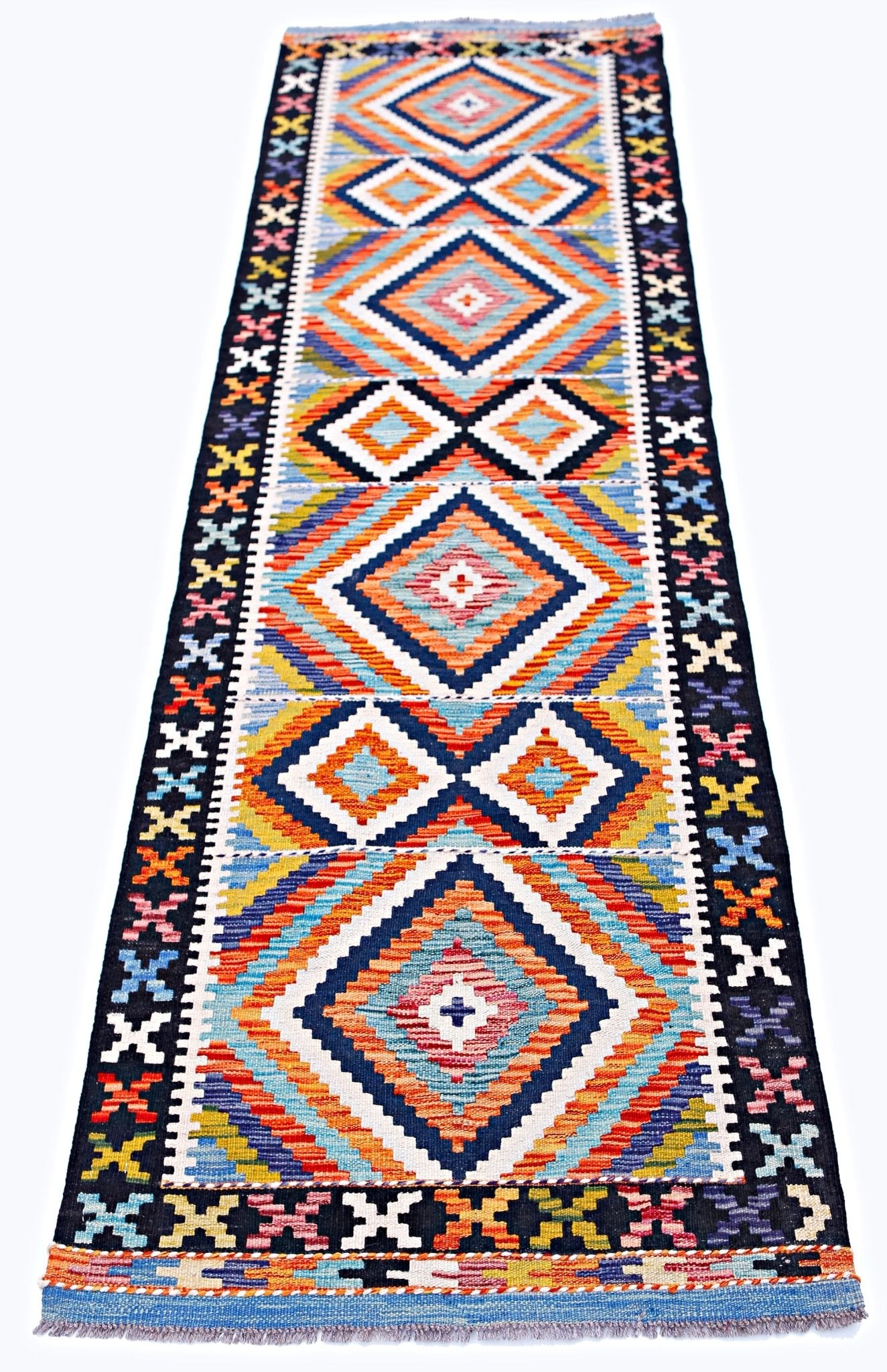 Handwoven Afghan Maimana wool runner featuring a vibrant geometric diamond pattern.