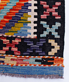 Handwoven Afghan Maimana wool kilim runner featuring vibrant geometric patterns and fringe edges.