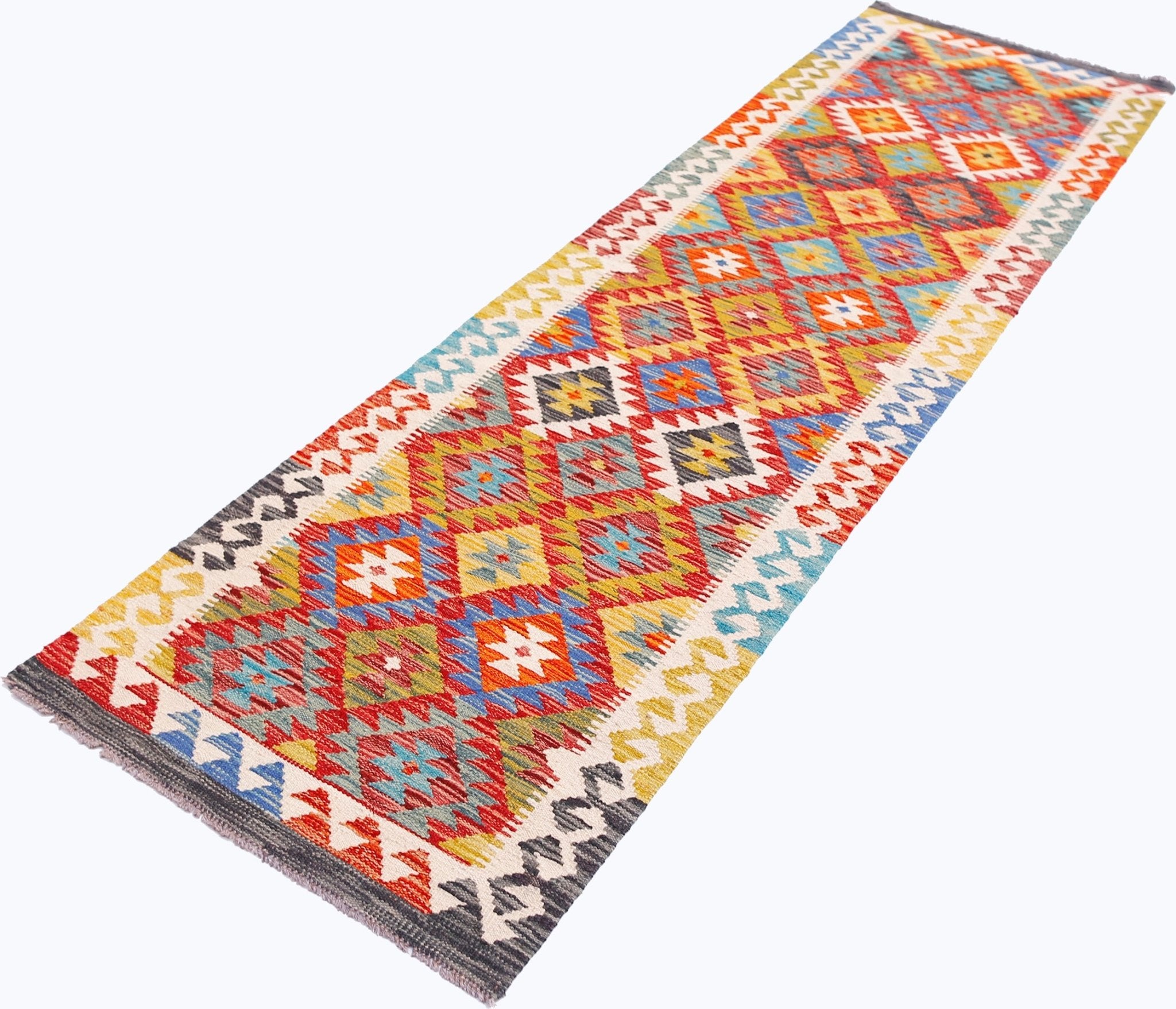A handmade Afghan Maimana wool runner rug featuring a colorful geometric diamond pattern.