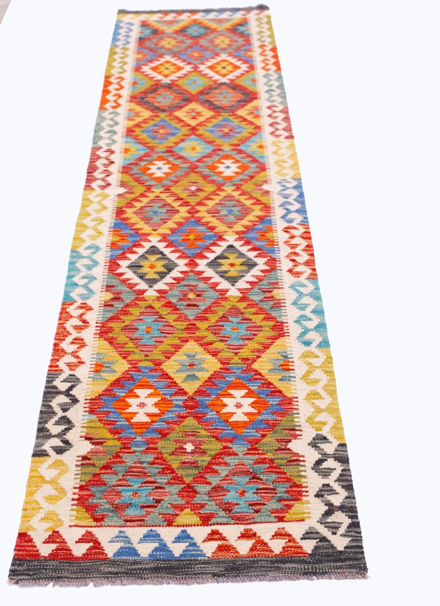 Handwoven Afghan Maimana wool runner featuring a colorful geometric diamond pattern.