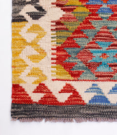 Handwoven Afghan Maimana kilim runner featuring a vibrant geometric pattern in wool.