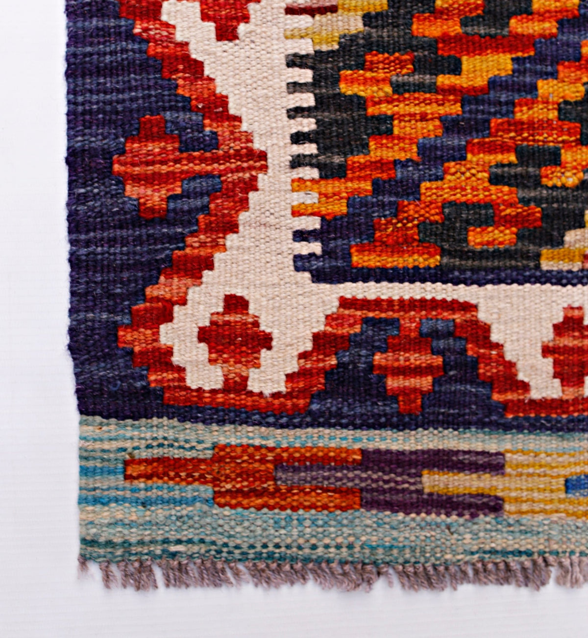 A handmade Afghan Maimana kilim runner featuring geometric patterns in red, blue, and cream.