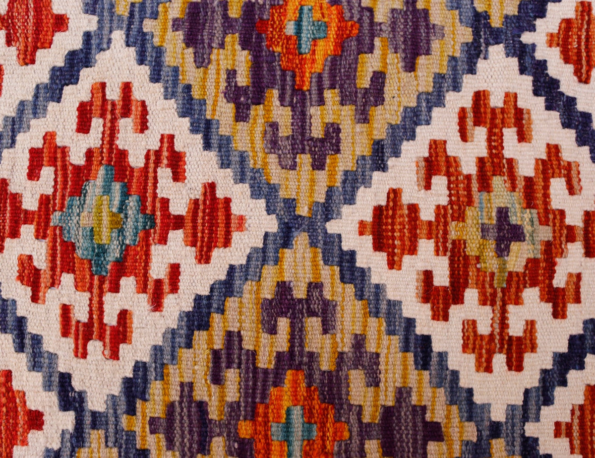 Handwoven Afghan Maimana kilim runner featuring a geometric pattern in red, blue, and yellow.