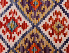 Handwoven Afghan Maimana kilim runner featuring a geometric pattern in red, blue, and yellow.