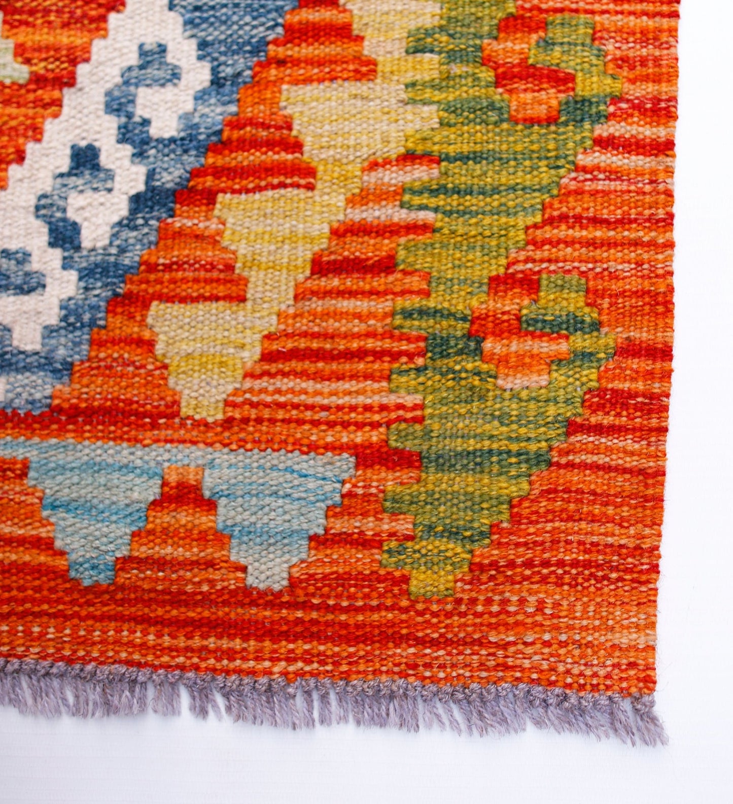 Handwoven Afghan Maimana wool kilim runner featuring a vibrant geometric pattern.
