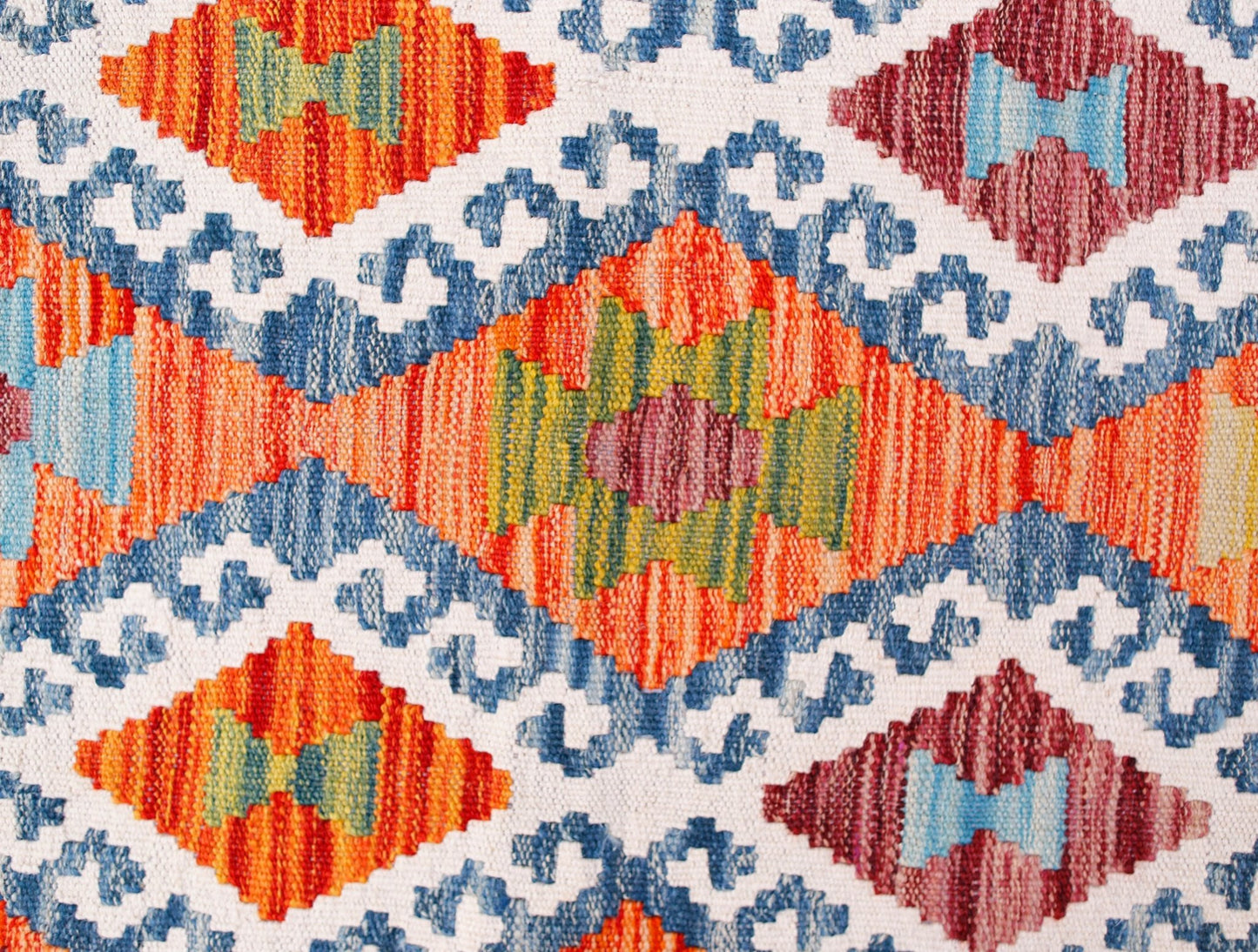 Handwoven Afghan Maimana kilim runner featuring a vibrant geometric diamond pattern in wool.