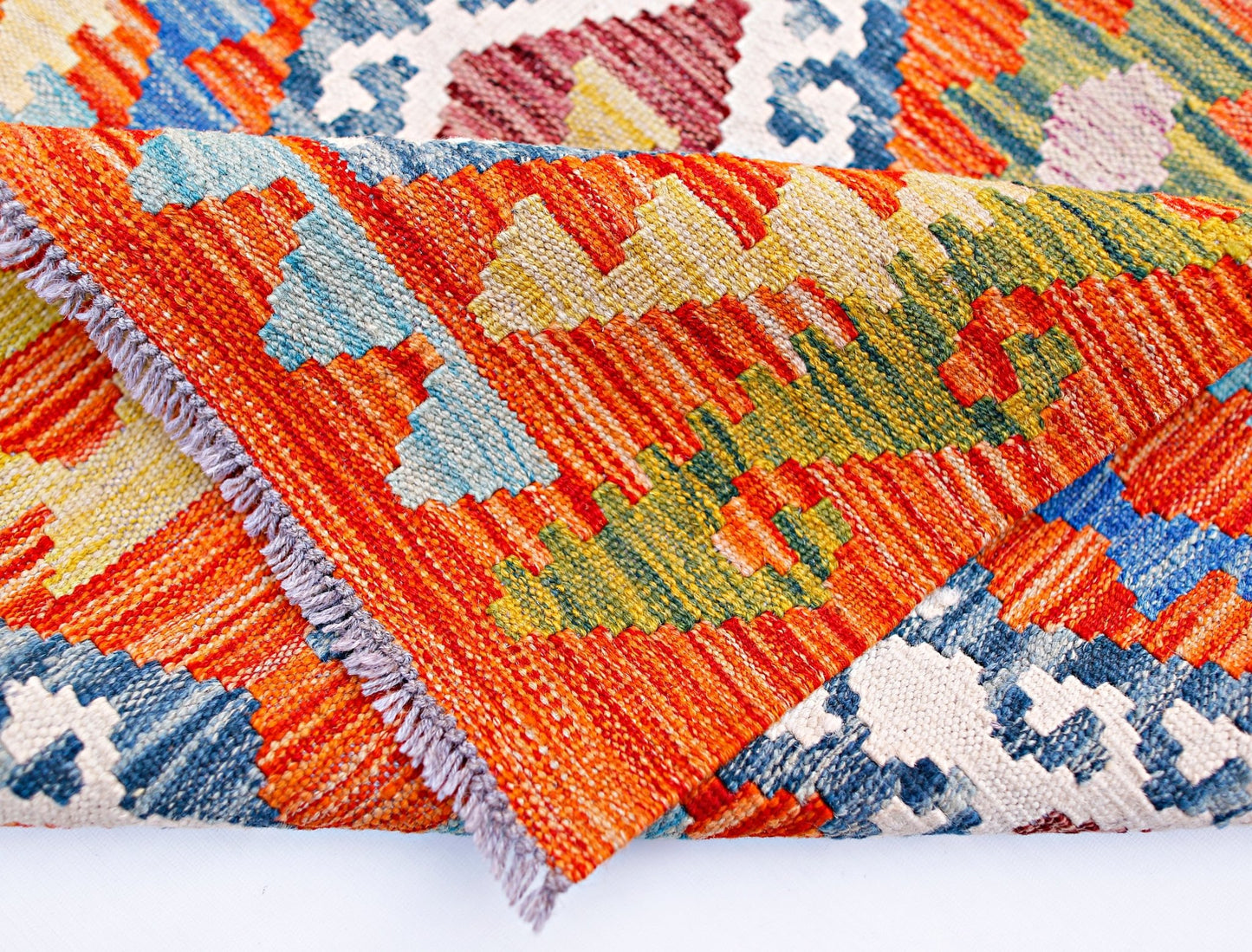 A handwoven Afghan Maimana kilim runner featuring vibrant geometric patterns in wool.