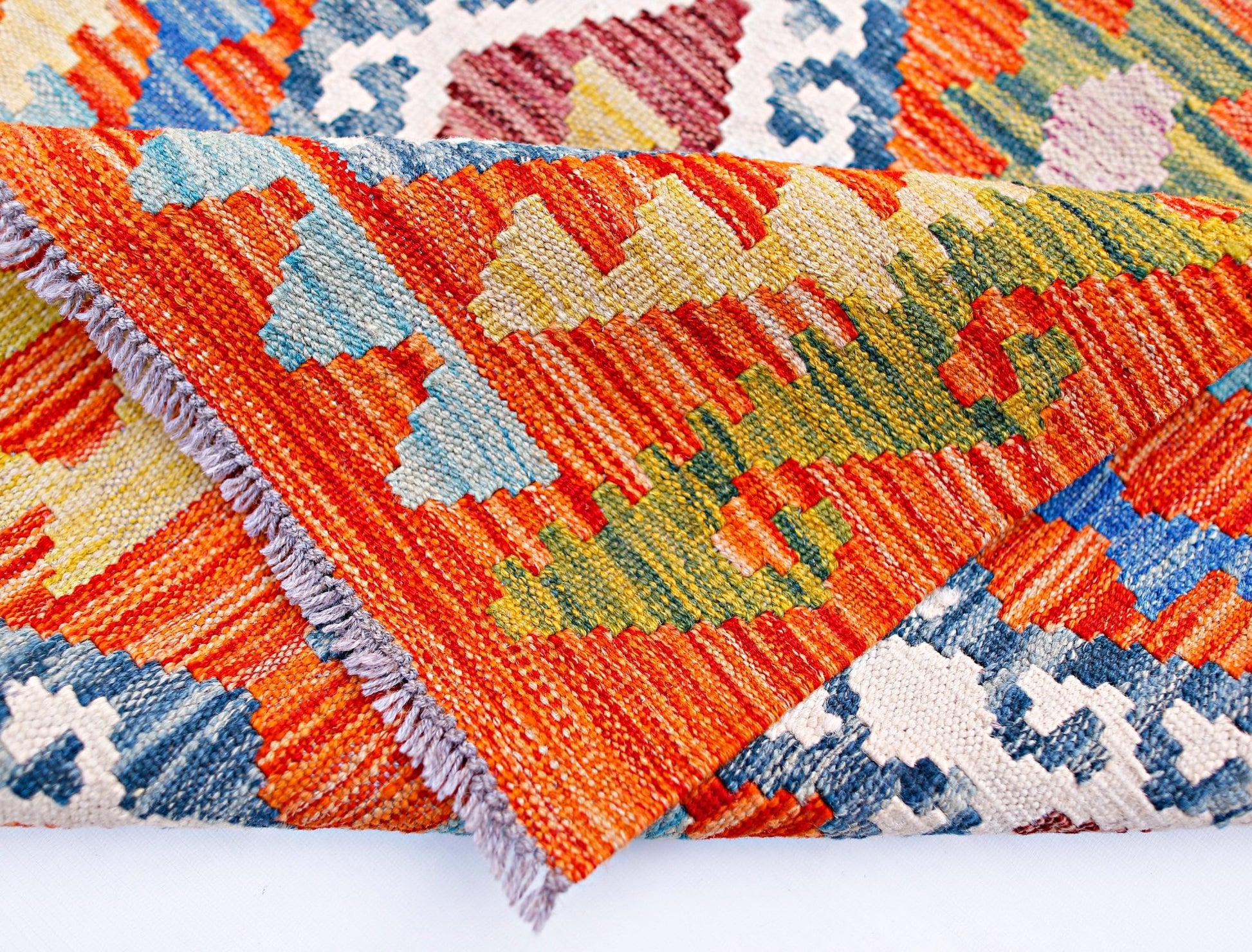 A handwoven Afghan Maimana kilim runner featuring vibrant geometric patterns in wool.