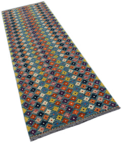 A handmade Afghan Maimana Kilim runner featuring a colorful geometric pattern on a blue background.