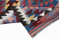 A handmade Afghan Maimana wool runner featuring a colorful geometric pattern.