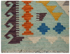 A handwoven Afghan Maimana kilim runner featuring geometric patterns in vibrant colors.