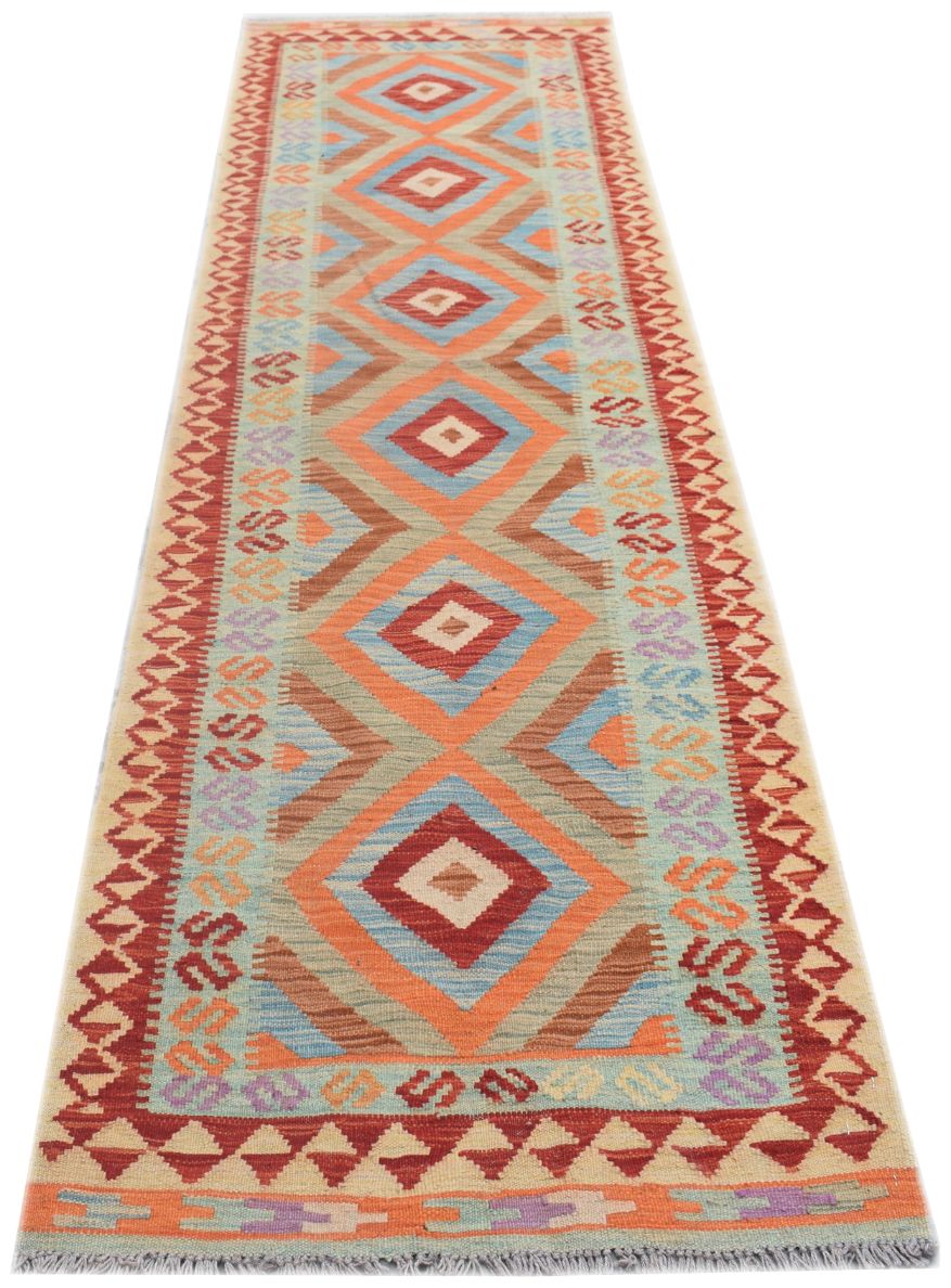 A handmade Afghan Maimana kilim runner featuring a repeating diamond pattern in vibrant colors.