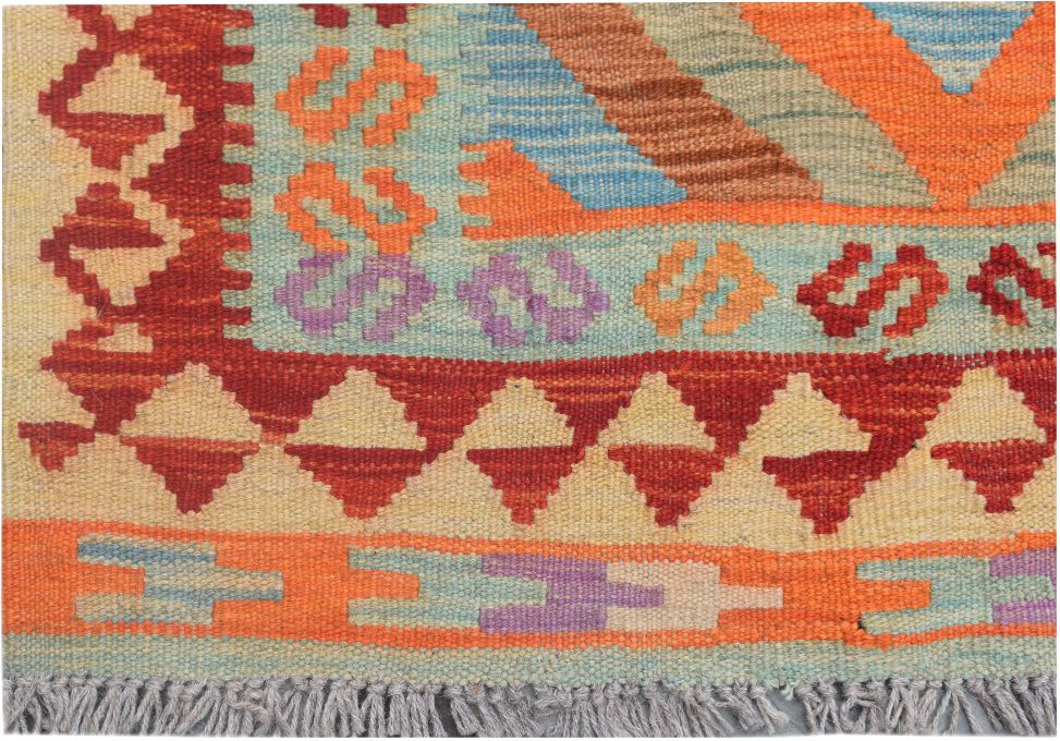 A handmade Afghan Maimana kilim runner featuring geometric patterns in vibrant, multicolored wool.