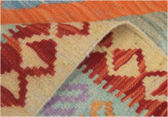 A close-up view of a handmade Afghan Maimana kilim runner featuring geometric patterns in wool.