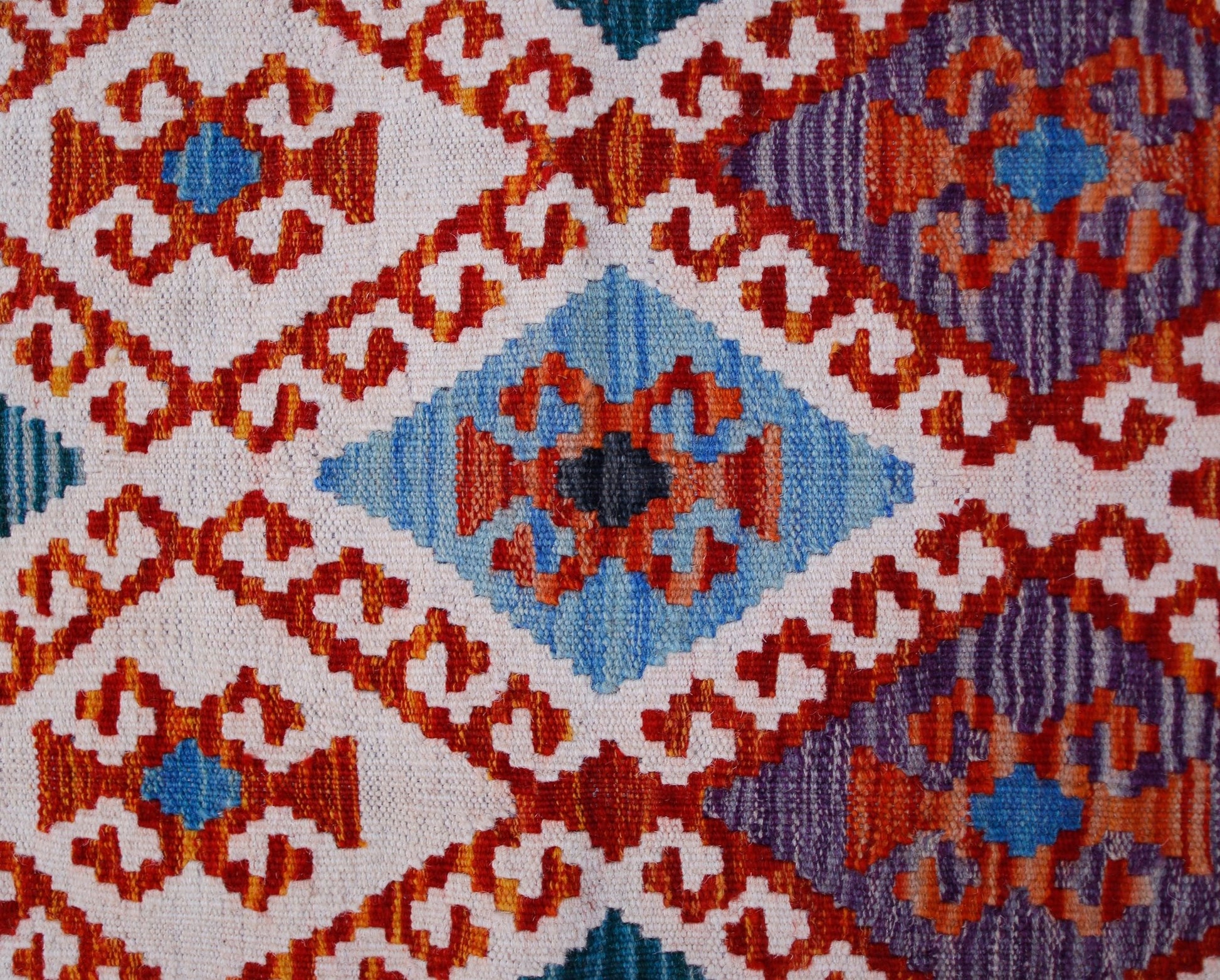 Handwoven Afghan Maimana kilim runner featuring a geometric diamond pattern in vibrant colors.