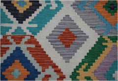 Handwoven Afghan Maimana kilim runner featuring a vibrant geometric pattern in wool.