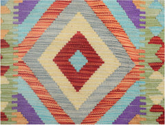 Handmade Afghan Maimana wool runner rug featuring a vibrant geometric diamond pattern.