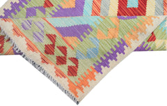 A handmade Afghan Maimana kilim runner featuring vibrant geometric patterns in wool.