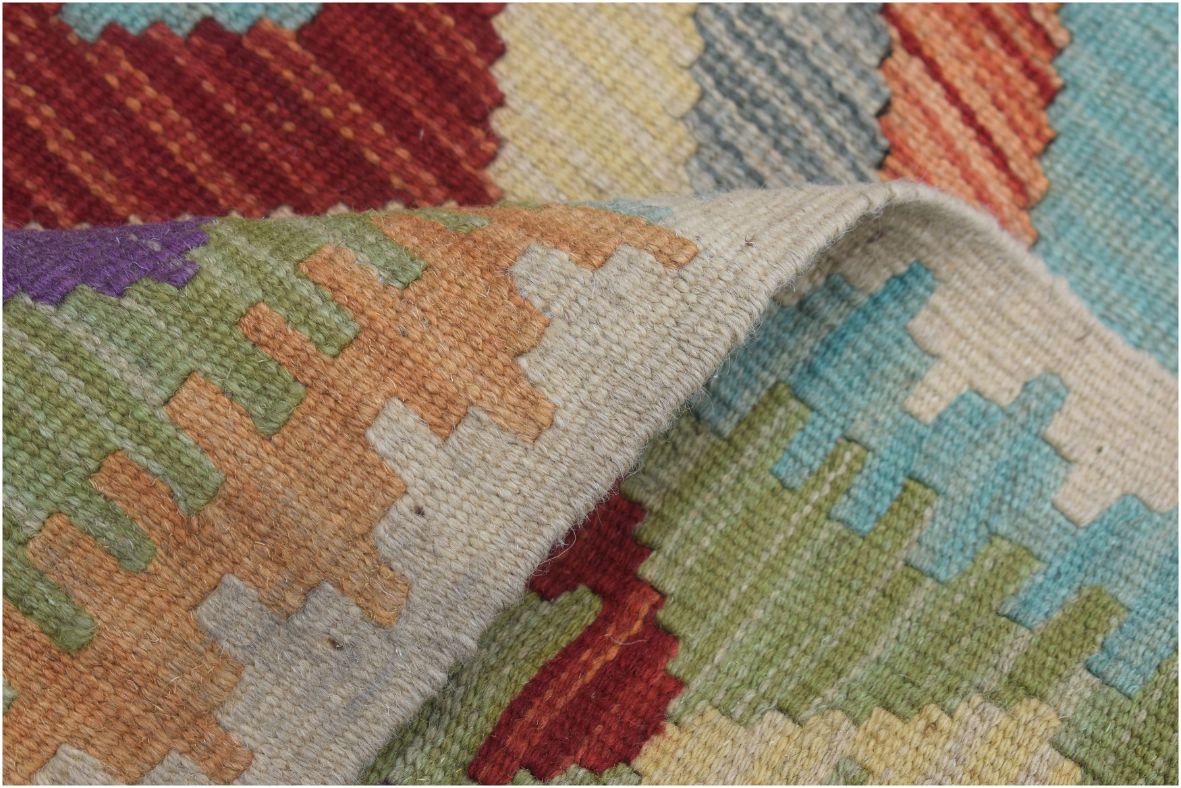 A handmade Afghan Maimana kilim runner featuring a colorful geometric pattern in wool.