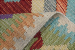 A handmade Afghan Maimana kilim runner featuring a colorful geometric pattern in wool.