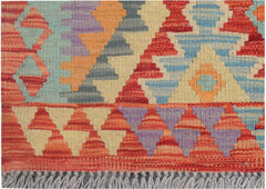 Handmade Afghan Maimana kilim runner featuring a vibrant geometric pattern in wool.