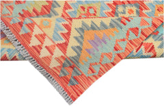 A handmade Afghan Maimana kilim runner featuring vibrant geometric patterns in wool.