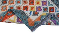 Handwoven Afghan Maimana wool runner featuring a colorful geometric pattern and fringed edges.
