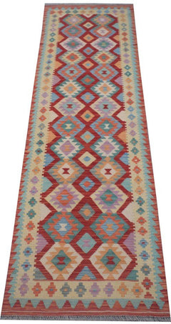 Handmade Afghan Maimana wool runner rug featuring a colorful geometric diamond pattern.