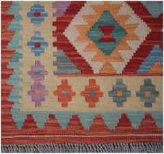 A handmade Afghan Maimana kilim runner featuring a vibrant geometric pattern in wool.
