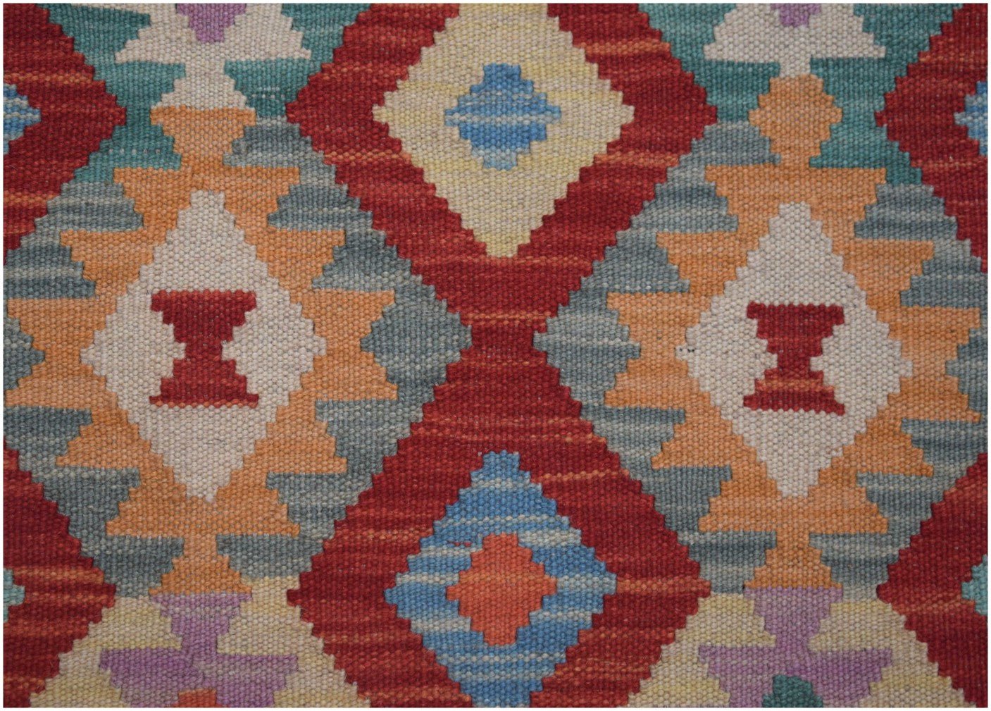 Handmade Afghan Maimana kilim runner featuring a vibrant geometric diamond pattern in wool.