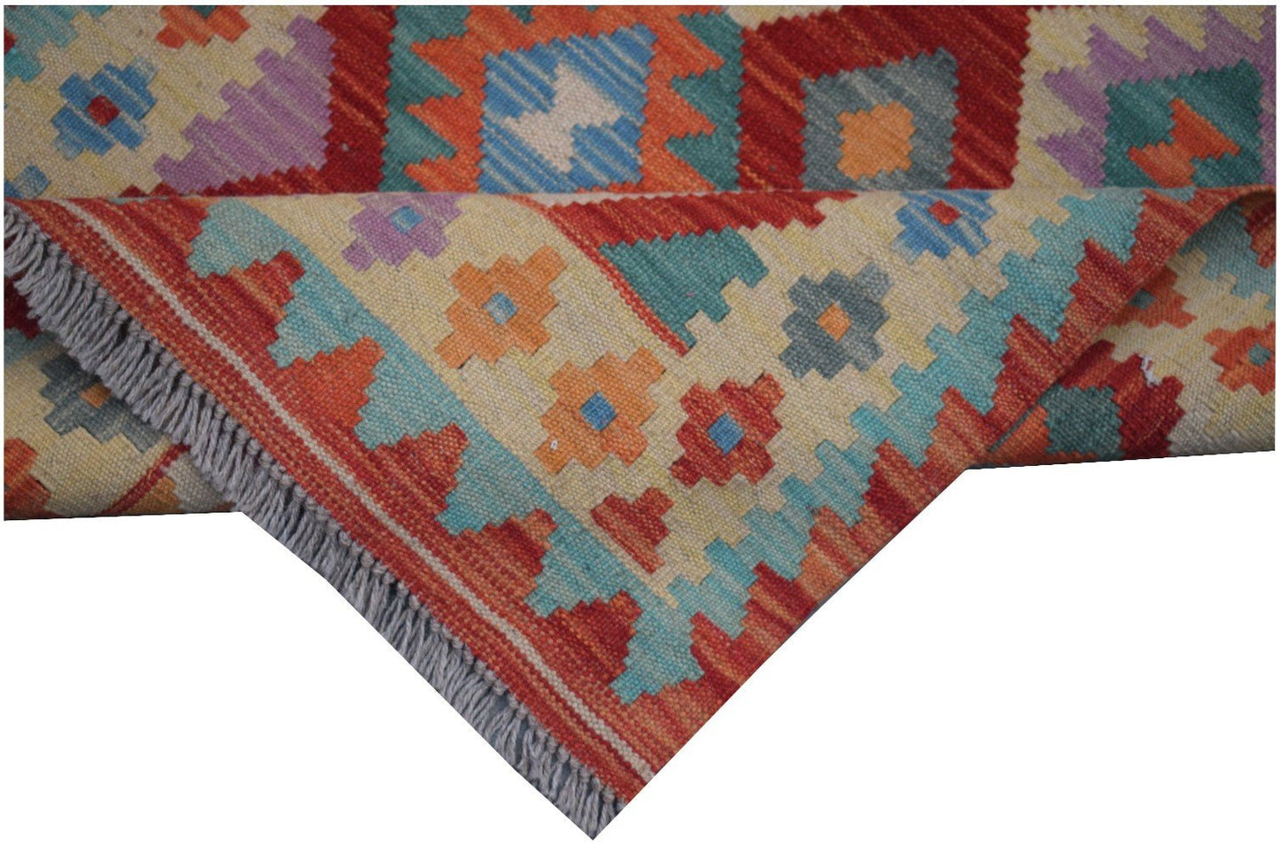 A handmade Afghan Maimana kilim runner featuring colorful geometric patterns and fringed edges.