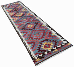 Handwoven Afghan Maimana wool runner rug featuring a colorful geometric diamond pattern.